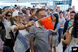 手举中国国旗的亲北京支持者在香港金融中心商场与反送中示威者发生对峙。（2019年9月12日）