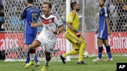 FILE - Germany's Mario Goetze celebrates after scoring on Argentina goalkeeper Sergio Romero during the World Cup final soccer match at the Maracana Stadium in Rio de Janeiro, Brazil, July 13, 2014.