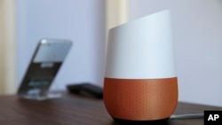 In this Tuesday, Oct. 4, 2016, file photo, Google Home, right, sits on display near a Pixel phone following a product event, in San Francisco. (AP Photo/Eric Risberg, File)