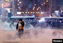 A man runs among the tear gas during a protest in Hong Kong,