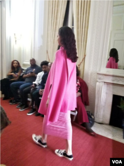 Model wears fuschia knitwear ensemble from Haitian designer Victor Glemaud's collection at the Haitian Embassy's "Diplomacy By Design" event in Washington, D.C., Feb. 23, 2018. (VOA / S. Lemaire)