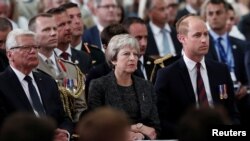 Britain's Prince William, the Duke of Cambridge, Britain's Prime Minister Theresa May and former German President Joachim Gauck attend a religious ceremony to mark the 100th anniversary of the WW1 Battle of Amiens, at the Cathedral in Amiens, Aug. 8, 2018.