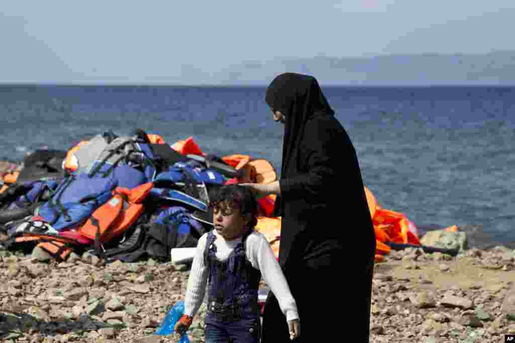 Migrants on the shores of the Greek island of Lesbos after crossing the Aegean sea from Turkey. More than 260,000 asylum-seekers have arrived in Greece so far this year, most reaching the country&#39;s eastern islands on flimsy rafts or boats from the nearby Turkish coast.