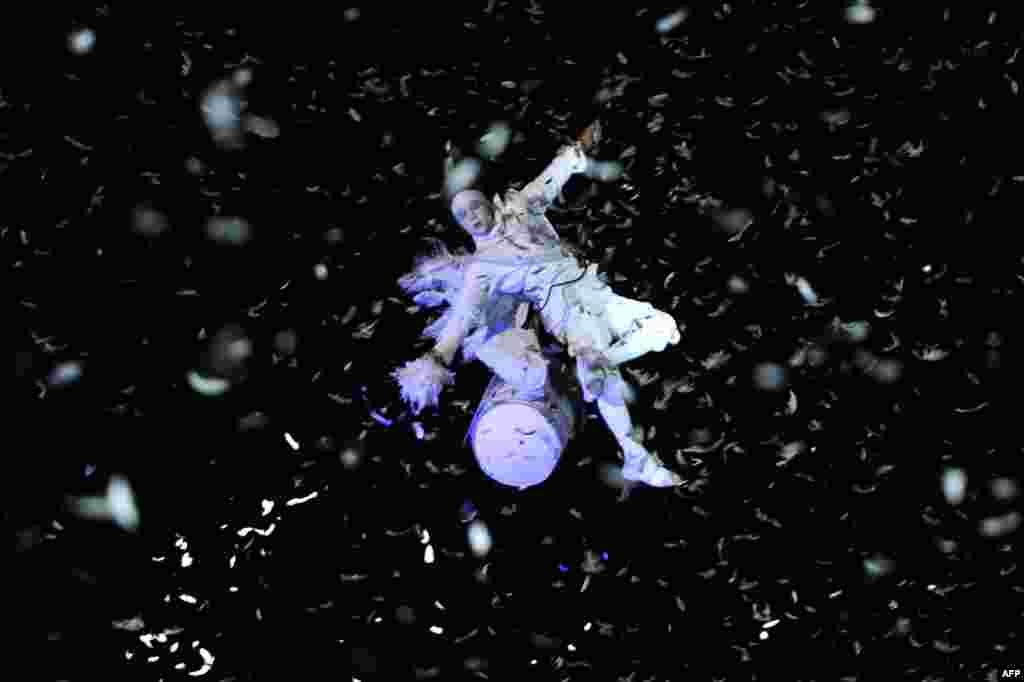 Artist from Studio de Cirque Company performs in the sky during 'Place des Anges' at the Cours d'Estienne d'Orves in Marseille, France. The event marks the start of a year, leading to a cultural renaissance in France's second-largest metropolitan area.