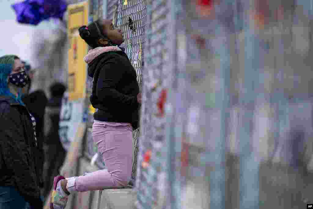 Nevaeh Gibson inspects a two-layer fenced perimeter around the Brooklyn Center Police Department during a protest in response to the shooting death of Daunte Wright, in Brooklyn Center, Minnesota, April 15, 2021.