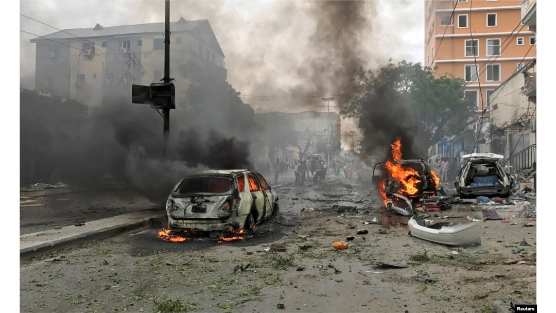 FILE - Vehicles burn at the scene of an explosion in Mogadishu, Somalia, July 30, 2017.