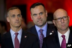 Republican presidential candidate Donald Trump Campaign Manager Corey Lewandowski, left, Dan Scavino, center, and Michael Glassner, watch as Ted Cruz gives his withdrawal speech during a primary night news conference, May 3, 2016, in New York.