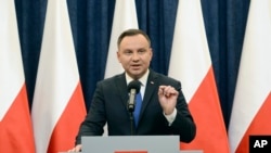 FILE - Polish President Andrzej Duda announces his decision to sign a legislation penalizing certain statements about the Holocaust, in Warsaw, Poland, Tuesday, Feb. 6, 2018. 