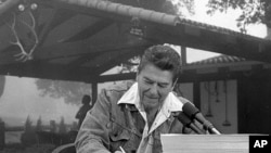 President Ronald Reagan signs a major tax cut bill at his ranch near Santa Barbara, California