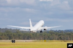 In this photo provided by the Australian Defense Force, a Royal Australian Air Force P-8 Poseidon aircraft departs an airbase in Amberly, Australia, Jan. 17, 2022, to assist the Tonga government after the eruption of an undersea volcano. (LACW Emma Schwenke / Australian Defence Force / AFP)