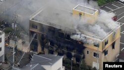 일본 교토의 3층 건물에서 18일 방화사건이 발생한 후 소방대원들이 화재 진압 작업을 하고 있다. 