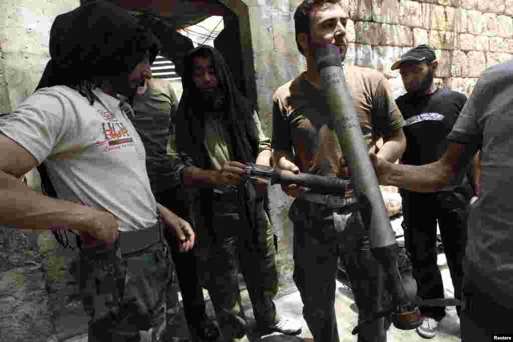 Free Syrian Army fighters display what they said were shells used by Syrian forces during clashes with them in Aleppo&#39;s Karm al-Jabal district, June 2, 2013.&nbsp;