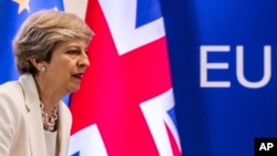 FILE - British Prime Minister Theresa May prepares to address a media conference at an EU summit in Brussels, June 23, 2017. May appears to be looking into an EFTA membership as an alternative to a "hard Brexit."