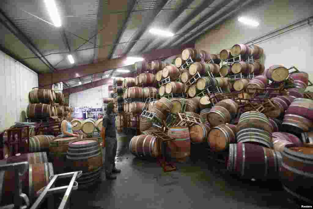 Andrew Brooks, associate winemaker of Bouchaine Vineyards, surveys fallen wine barrels after a 6.0 earthquake in Napa, California Aug. 24, 2014.