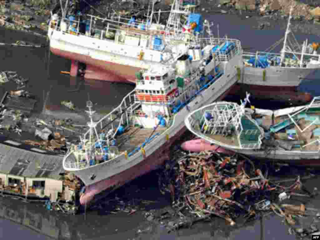Vessels get stranded in Kesennuma, Miyagi prefecture, northern Japan, Saturday, March 12, 2011, after being washed away by an earthquake-triggered tsunami.