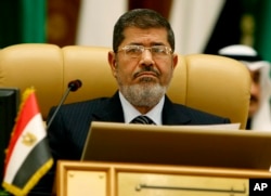 FILE - Egypt's first freely elected civilian President Mohamed Morsi attends the third session of the Arab Economic Summit, in Riyadh, Saudi Arabia, Jan. 21, 2013.