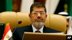 FILE - Egyptian President Mohamed Morsi attends the third session of the Arab Economic Summit, in Riyadh, Saudi Arabia, Monday, Jan. 21, 2013. 
