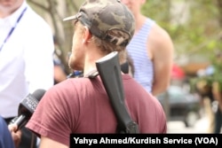 Jesse Gonzalez of Lakewood, Ohio, who carried his rifle with him, speaks to the media after arriving near the Republican National Convention in downtown Cleveland, July 18, 2016.