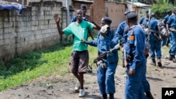 Burundian police arrest a demonstrator during clashes with security forces in the Cibitoke district of the capital Bujumbura, Burundi Friday, May 29, 2015.