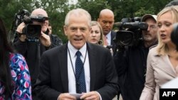 FILE - White House trade and economic adviser Peter Navarro, center, speaks to the press at the White House, June 4, 2018.