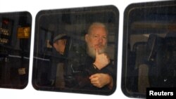 WikiLeaks founder Julian Assange is seen in a police van after he was arrested by British police outside the Ecuadorian embassy in London, April 11, 2019.