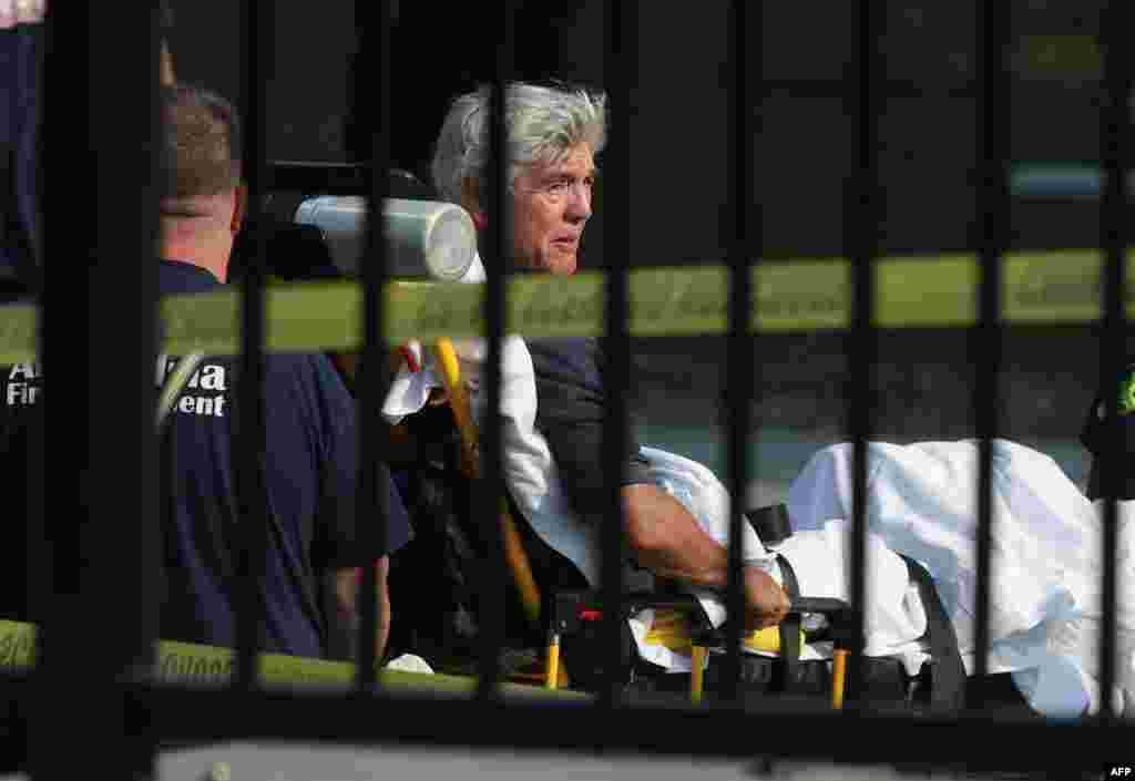 Rep. Roger Williams (R-TX) is wheeled away by emergency medical service personnel from the Eugene Simpson Stadium Park, June 14, 2017 in Alexandria, Virginia. House Majority Whip Steve Scalise (R-LA) was among five wounded in the attack, including the suspected gunman, as Republican Congressional members practiced for a charity baseball game.