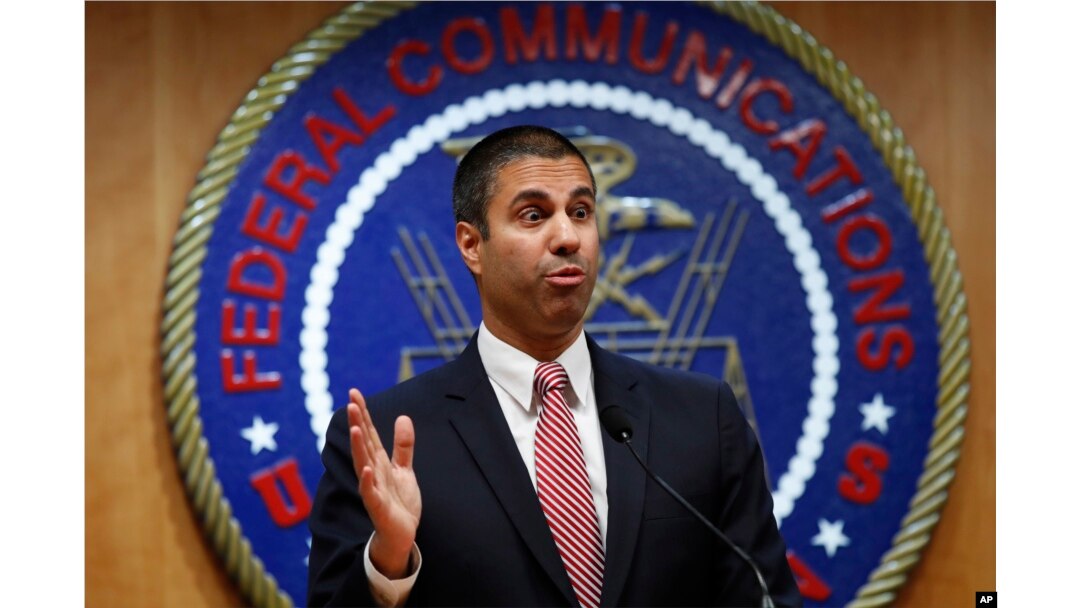 FILE - After a meeting voting to end net neutrality, Federal Communications Commission Chairman Ajit Pai answers a question from a reporter, Dec. 14, 2017, in Washington.