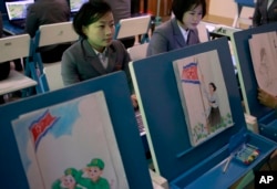 Students make storyboards depicting North Korean flags being raised during a multimedia production class at Pyongyang Teachers' University, a teacher training college, in Pyongyang, North Korea, Jan. 29, 2019.