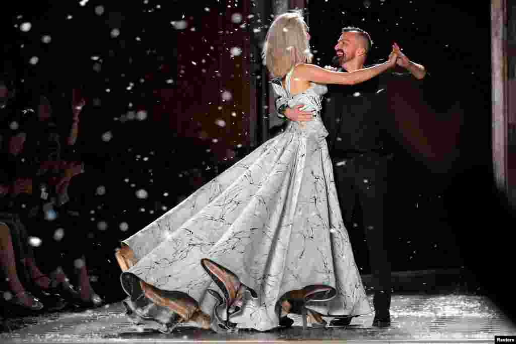 French designer Julien Fournie dances with a model at the end of his Haute Couture Fall/Winter 2019/20 collection show in Paris.