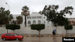 FILE - A car drives past the Italian embassy in Tripoli, Libya, Jan. 10, 2017. 