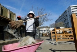 Zion Mcleod, 13, sweeps out the stables at the Ebony Horse Club.