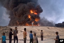 Islamic State fighters torched a sulfur plant in Qayyarah, about 31 miles (50 km) south of Mosul, Iraq, sending a cloud of toxic fumes into the air that mingled with oil wells the militants had lit on fire to create a smoke screen.