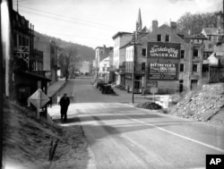 This is a photo of Shenandoah Street in Harpers Ferry, West Virginia, in March 1938. Harpers Ferry town, located at the confluence of the Shenandoah and Potomac rivers, was an important arms-producing center by the mid 1800s.