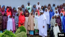 FILE - Nigeria's President Muhammadu Buhari meets with some of the newly released Dapchi schoolgirls in Abuja, Nigeria, March 23, 2018.