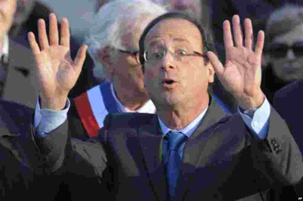 Francois Hollande, Socialist Party candidate for the 2012 French presidential election, waves after his speech at a ceremony in Paris to mark the mass killing of Armenians by Ottoman Turks 97 years ago Tuesday, April 24, 2012. (AP Photo/Philippe Wojazer/P