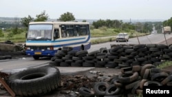 A bus drives past a pro-Russian activists checkpoint outside the eastern Ukrainian city of Druzhkovka, June 2, 2014.