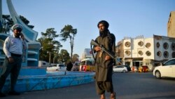 A Taliban fighter patrols along a street in Herat, September 19, 2021.