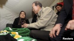 U.N. Secretary-General Ban Ki-moon, second from left, chats with Syrian refugee woman at camp in Islahiye, Gaziantep province, Turkey, Dec. 7, 2012.