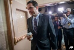 House Intelligence Committee Chairman Rep. Devin Nunes, R-Calif. is pursued by reporters as he arrives for a weekly meeting of the Republican Conference with House Speaker Paul Ryan and the GOP leadership, March 28, 2017, on Capitol Hill in Washington.