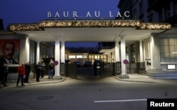 Members of the media stand outside the Baur au Lac hotel where Swiss police arrested FIFA officials, in Zurich, Switzerland, Dec. 3, 2015.