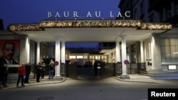 Members of the media stand outside the Baur au Lac hotel where Swiss police arrested FIFA officials, in Zurich, Switzerland, Dec. 3, 2015.