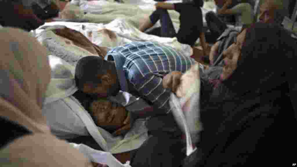 Egyptians mourn over the bodies of their relatives in the El-Iman mosque, Thursday, Aug. 15, 2013.