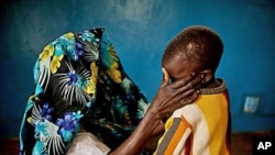 A mass rape victim comforts her son in the town of Fizi, Congo, February 20, 2011