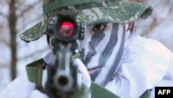 A South Korean Marine aims his rifle on a snowy hill during a joint winter drill with US Marines in Pyeongchang, some 180 kilometers east of Seoul.