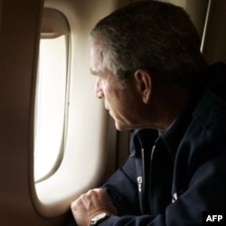 President Bush looks out the window of Air Force One over New Orleans, to inspect the damage from Hurricane Katrina