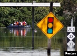 A rescue team navigates its boat through the flooded streets as the Tar River crests in the aftermath of Hurricane Matthew, in Princeville, North Carolina, Oct. 13, 2016. Matthew delayed the launch of a weather satellite that will help save lives by better forecasting hurricanes and other storms, NOAA officials say.