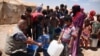 Norwegian Refugee Council staff dispense drinking water to Iraqis at Amariyat Al Fallujah displacement camp. (NRC courtesy photo)
