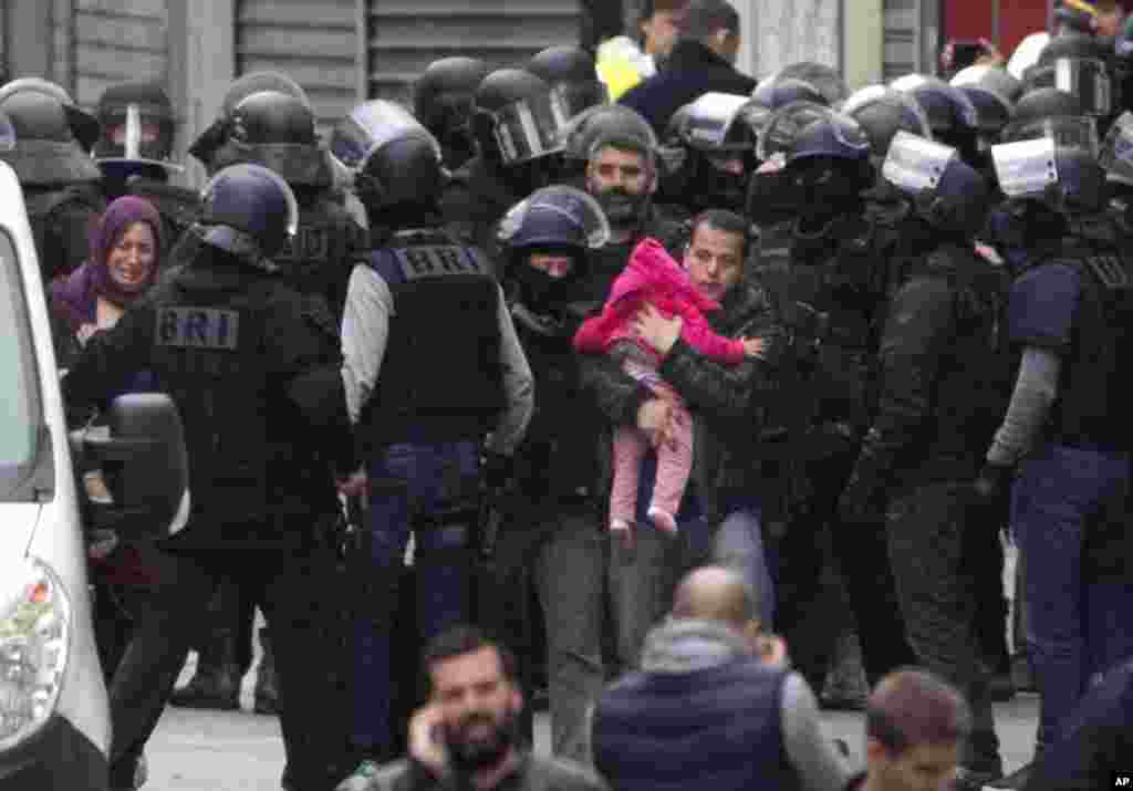 Residents are evacuated from Saint Denis, near Paris, Nov. 18, 2015.