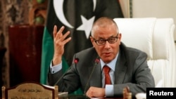 Libya's Prime Minister Ali Zeidan speaks during a joint news conference with Oil Minister Abdelbari al-Arusi at the Prime Minister's Office in Tripoli, July 2013.
