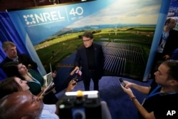 U.S. Secretary of Energy Rick Perry speaks to reporters at an Earth Day display at Fair Park in Dallas, April 21, 2017.